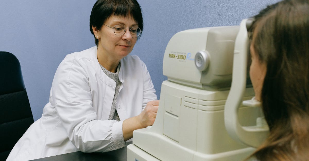 A healthcare professional conducts an eye exam using advanced technology in a clinical setting.